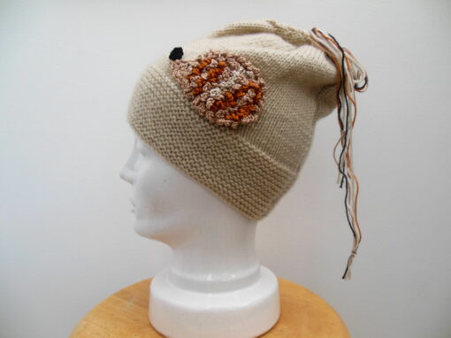 hand knit Hedgehog hat on a porcelain head